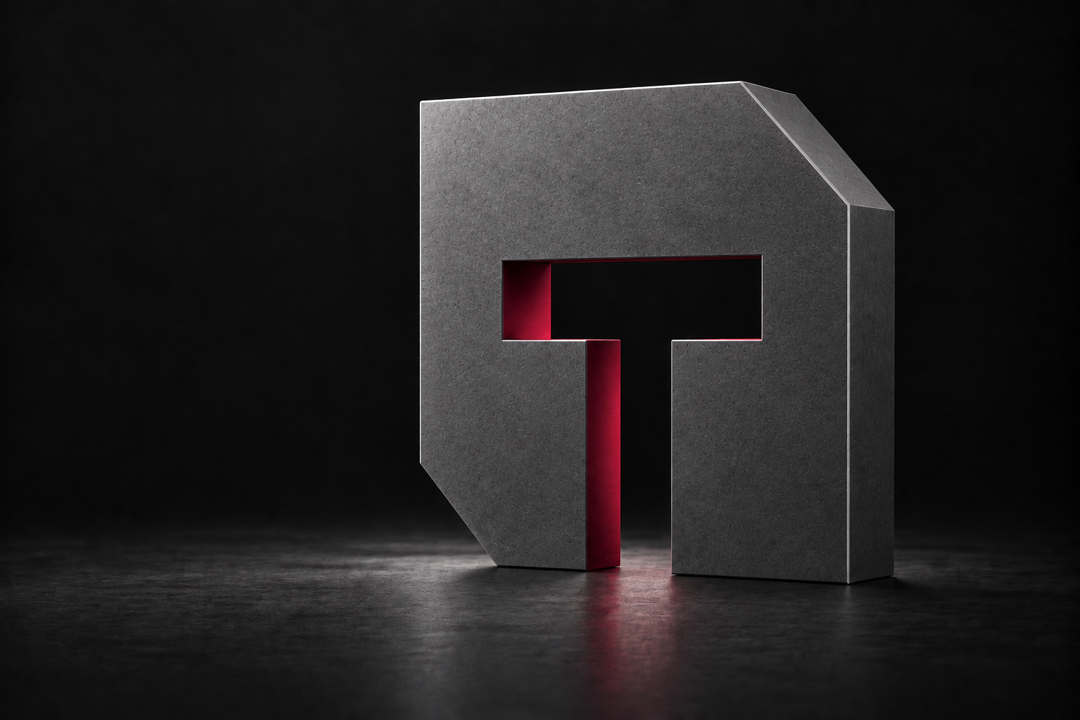 TEQURE’s angular T emblem rendered as a graphite sculpture